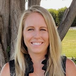 Sarah Ballard smiling with a tree in the background