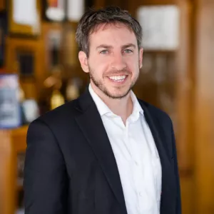 Mike Pronovost Smiling wearing a suit